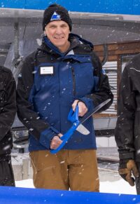 Karl Strand cutting the ribbon at Sugarloaf's Bucksaw Express
